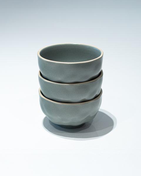 Stack of 3 Noodle bowls with a dimpled ceramic finish in grey for hire
