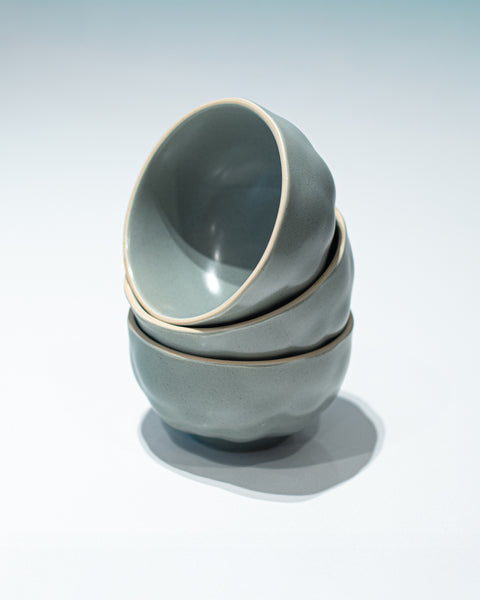 Stack of 3 Noodle bowls with a dimpled ceramic finish in grey for hire