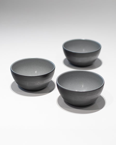 Three gray bowls on a white background