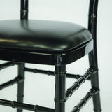 detail of Black resin banquet chair with cushion